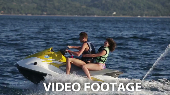 Happy Couple Riding Jet Ski Happy Couple Riding Jet Ski
