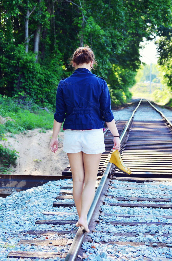 Girl walking on train tracks ~ People Photos on Creative Market