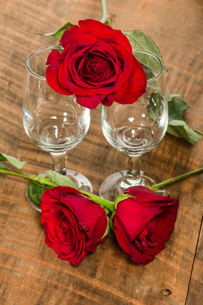Wine glasses and red roses Holiday Photos on Creative Market